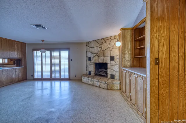 a view of a fireplace and an empty room