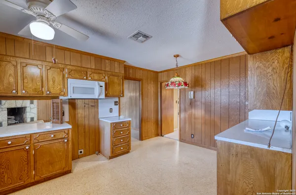a view of an empty room with a fireplace and a window
