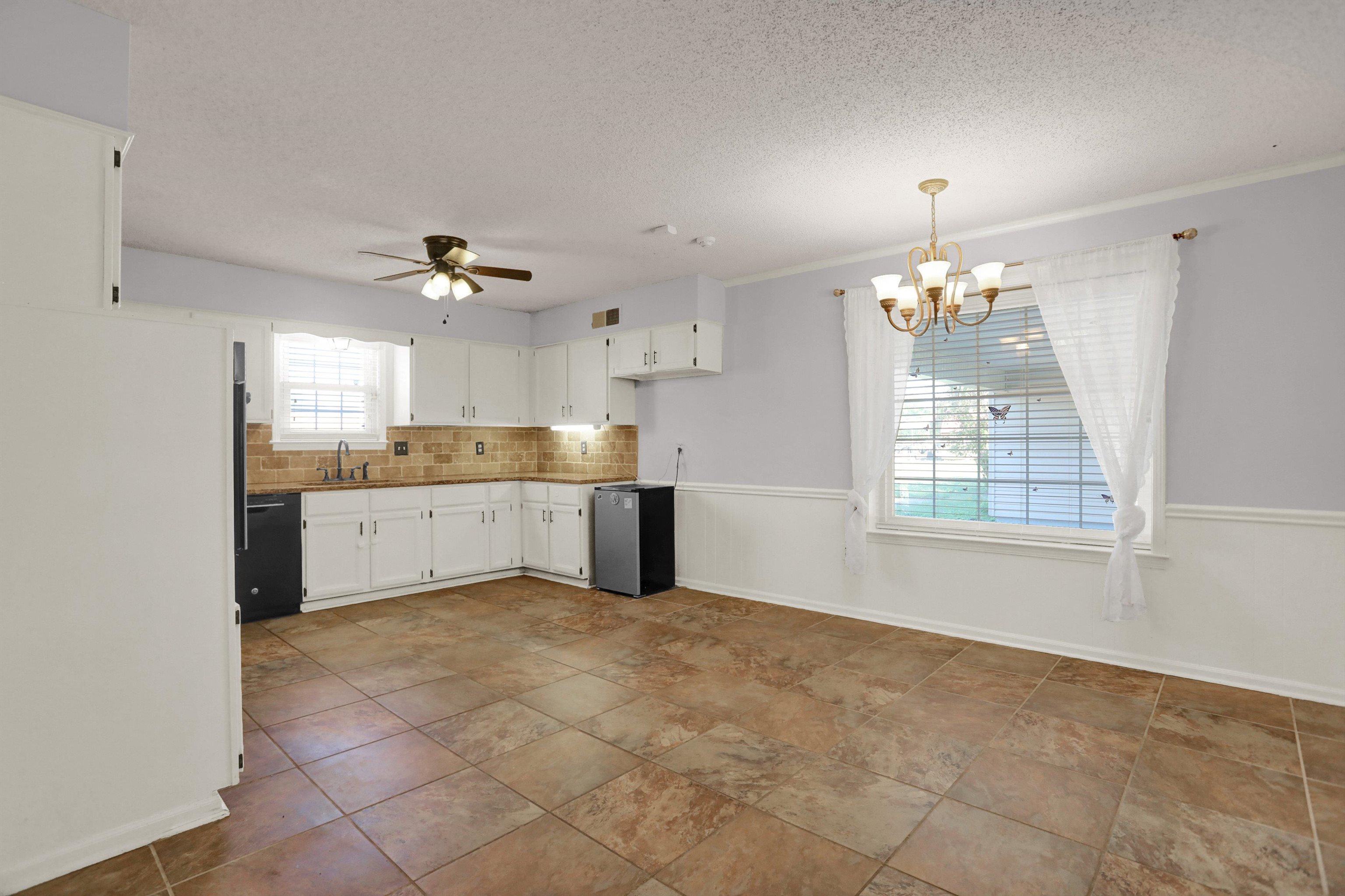 11670 Macon Road Eads, TN 38028 - Photo 12 of 40 a view of a kitchen with a sink and chandelier