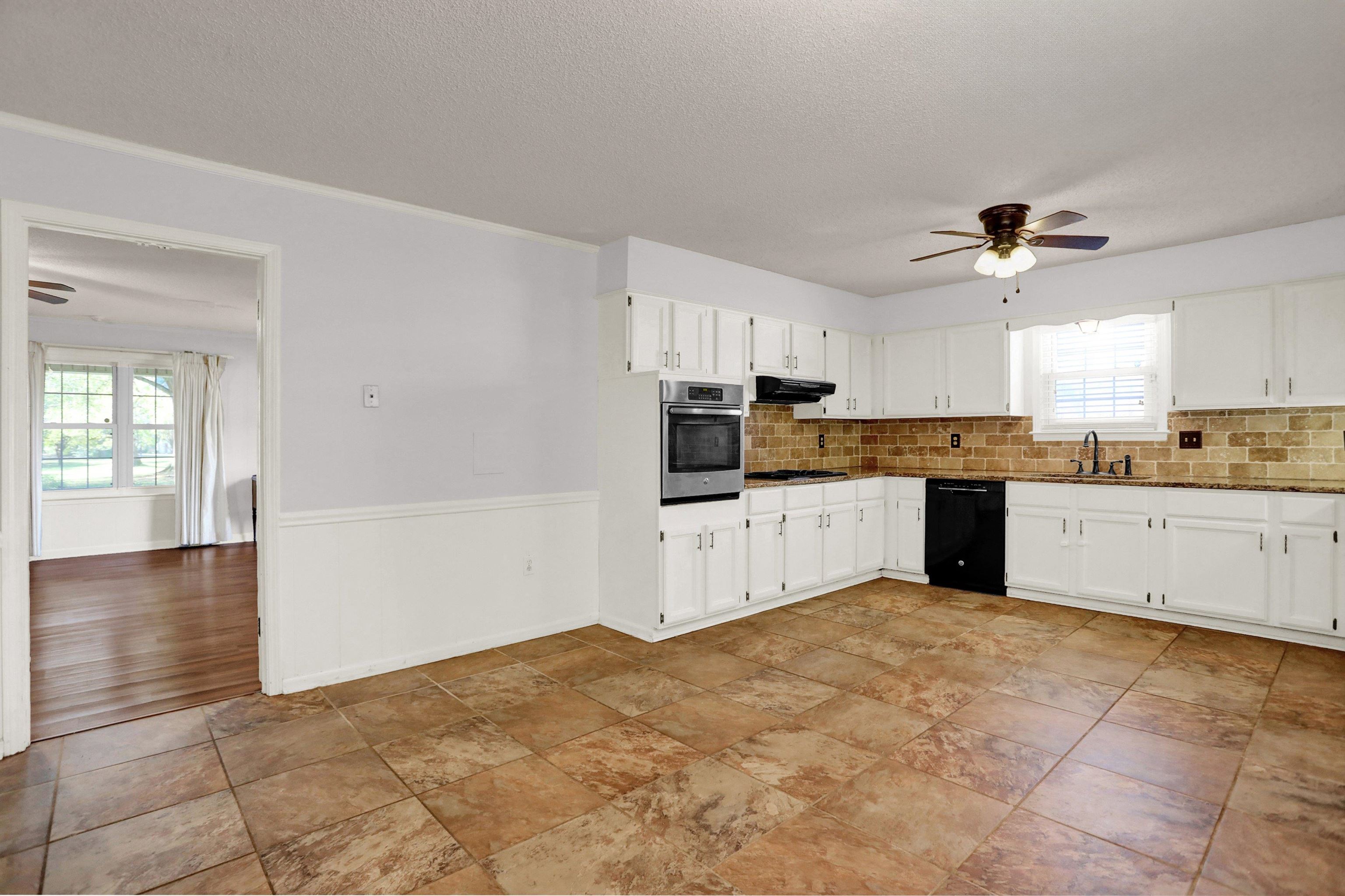 11670 Macon Road Eads, TN 38028 - Photo 13 of 40 a large kitchen with cabinets and stainless steel appliances