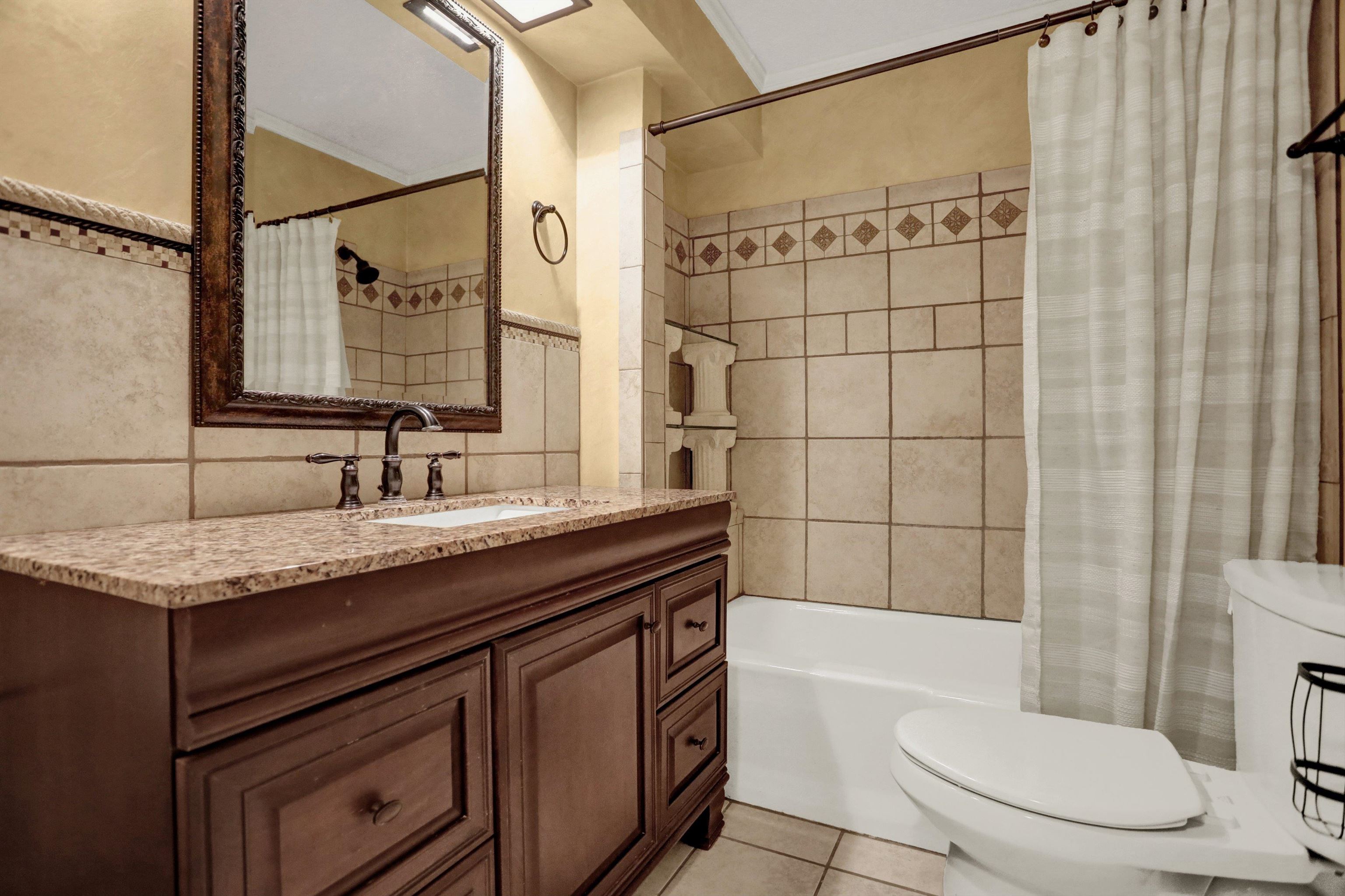 11670 Macon Road Eads, TN 38028 - Photo 18 of 40 a bathroom with a granite countertop sink toilet and shower