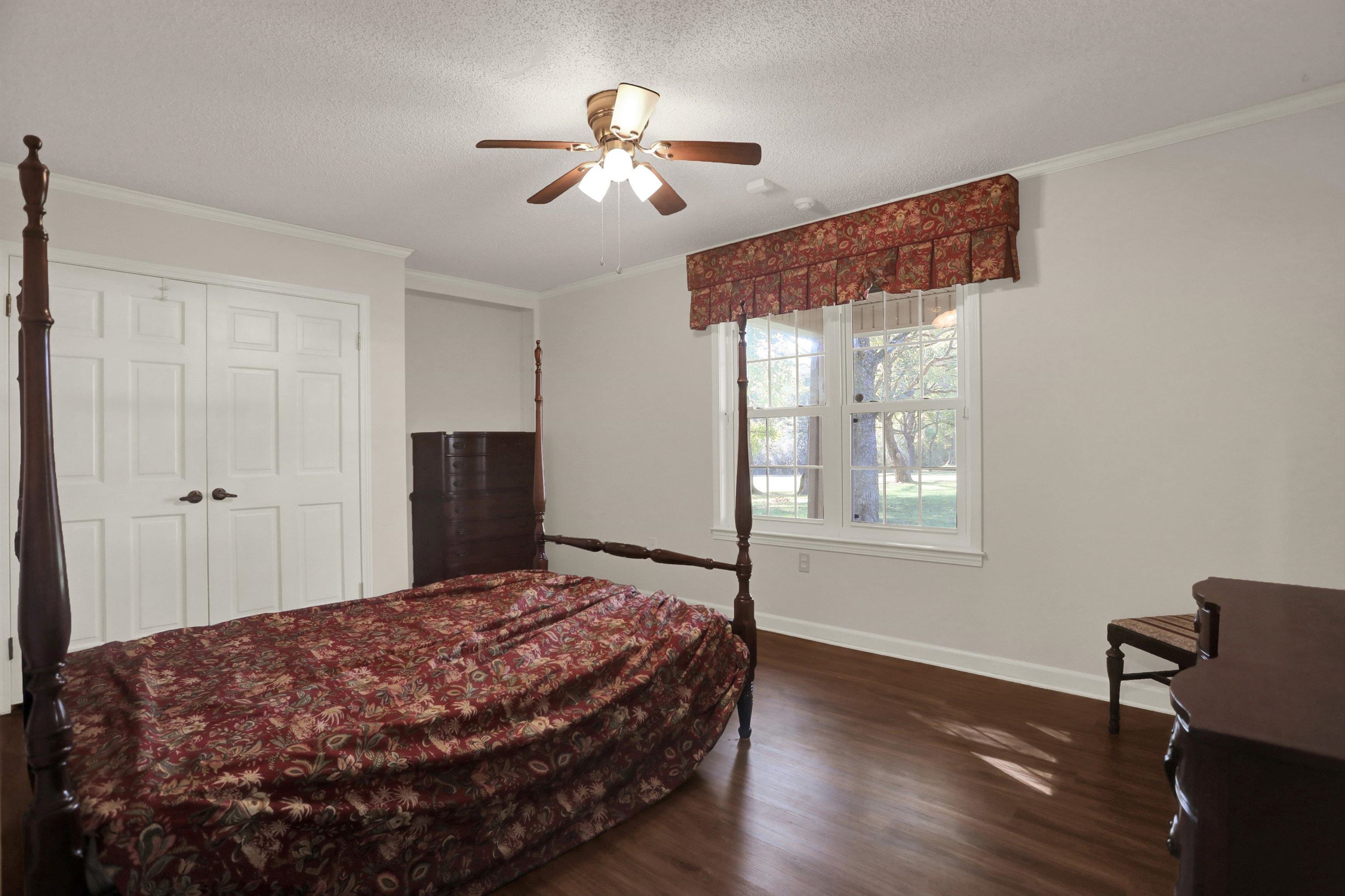 11670 Macon Road Eads, TN 38028 - Photo 21 of 40 a bedroom with a bed chandelier and a window