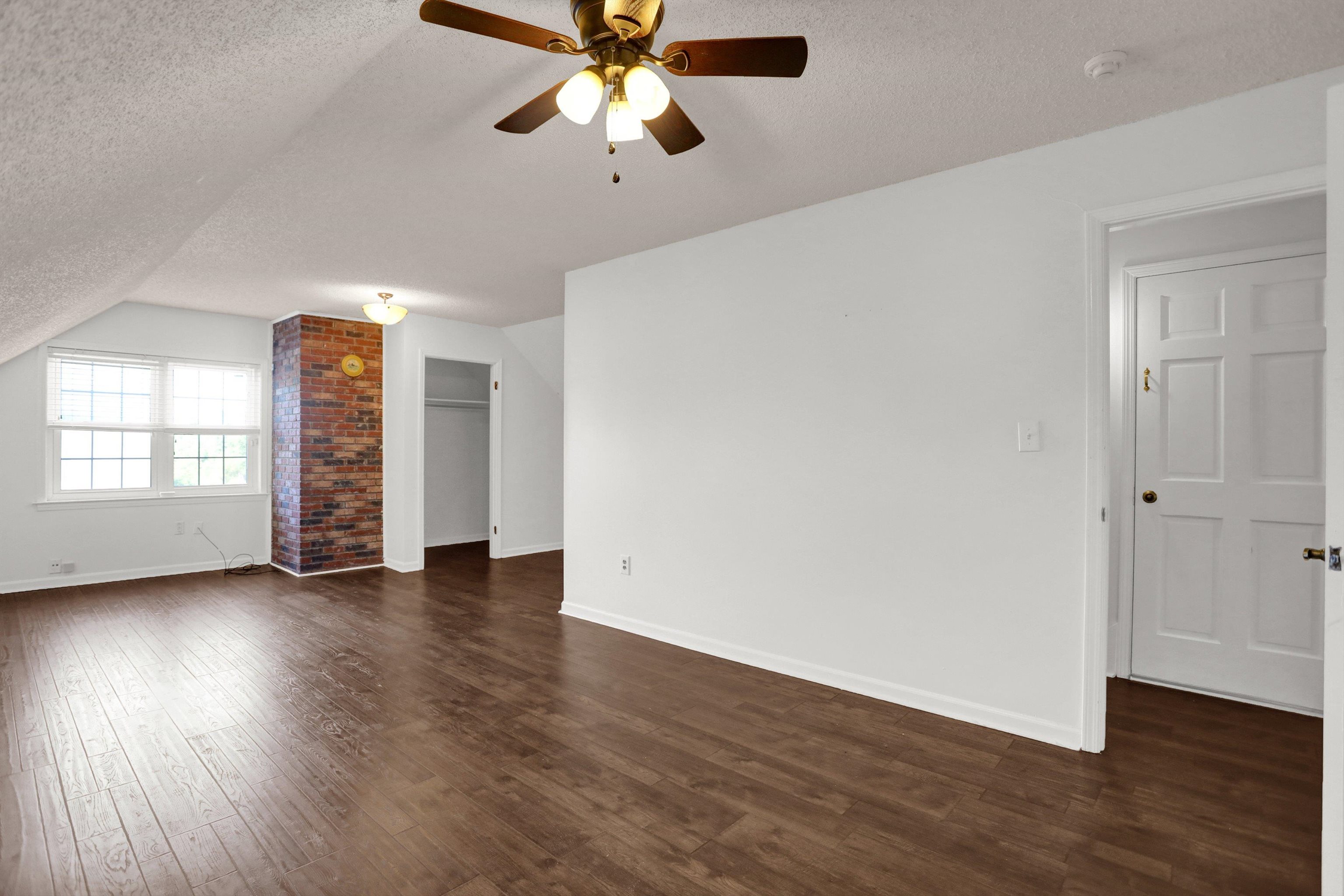 11670 Macon Road Eads, TN 38028 - Photo 27 of 40 an empty room with wooden floor chandelier fan and windows