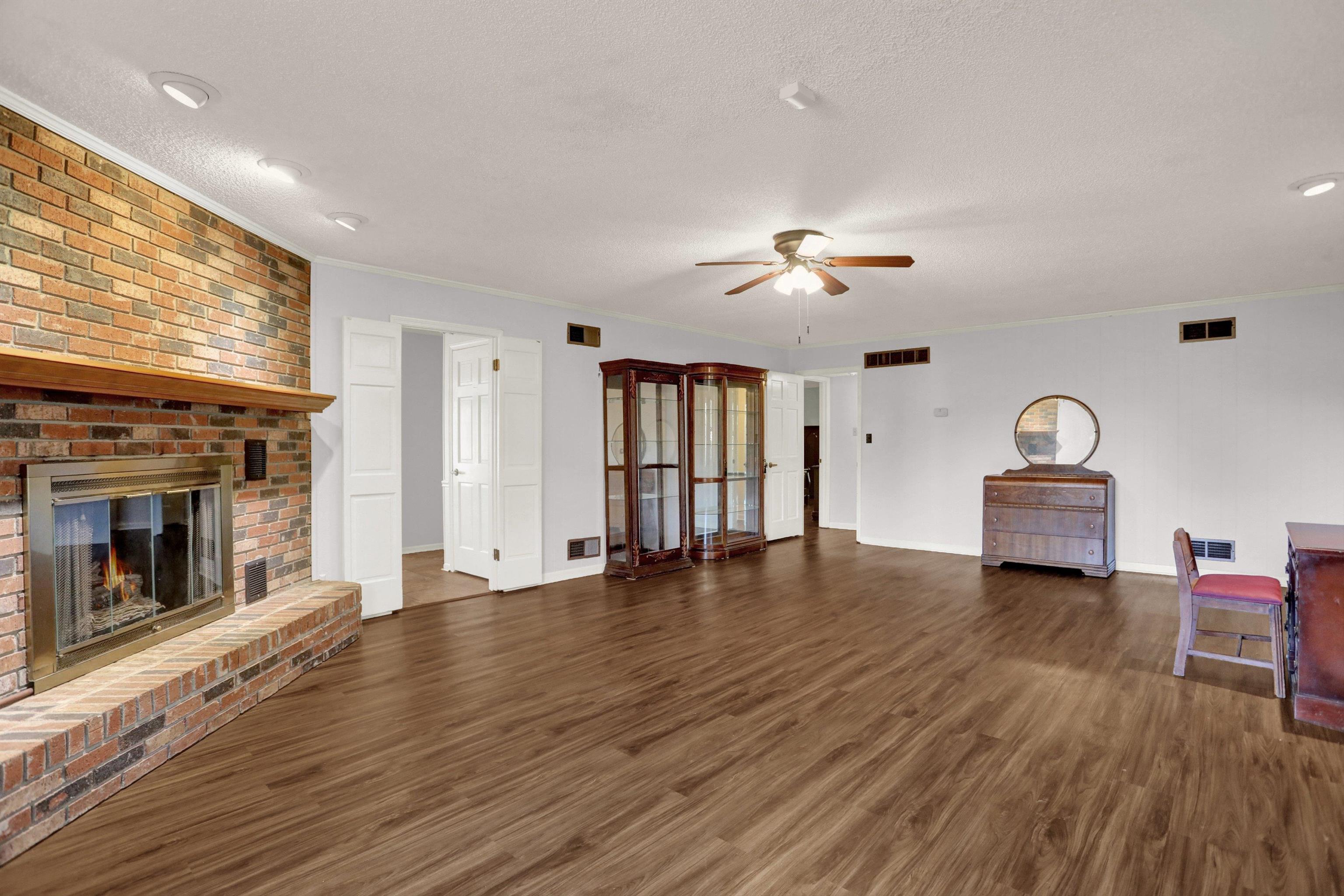 11670 Macon Road Eads, TN 38028 - Photo 8 of 40 an empty room with wooden floor fireplace and window
