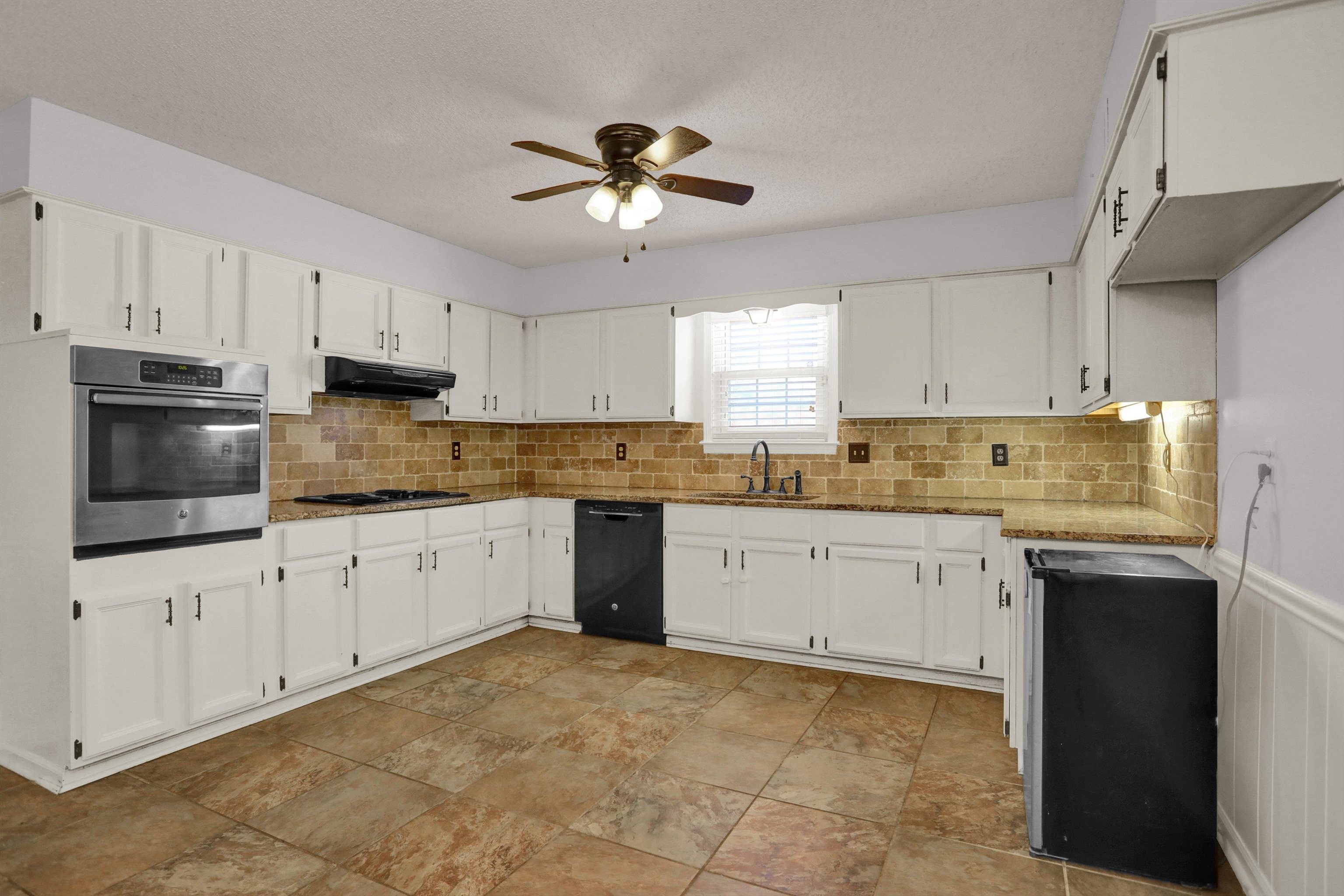 11670 Macon Road Eads, TN 38028 - Photo 9 of 40 a kitchen with granite countertop a stove sink and cabinets