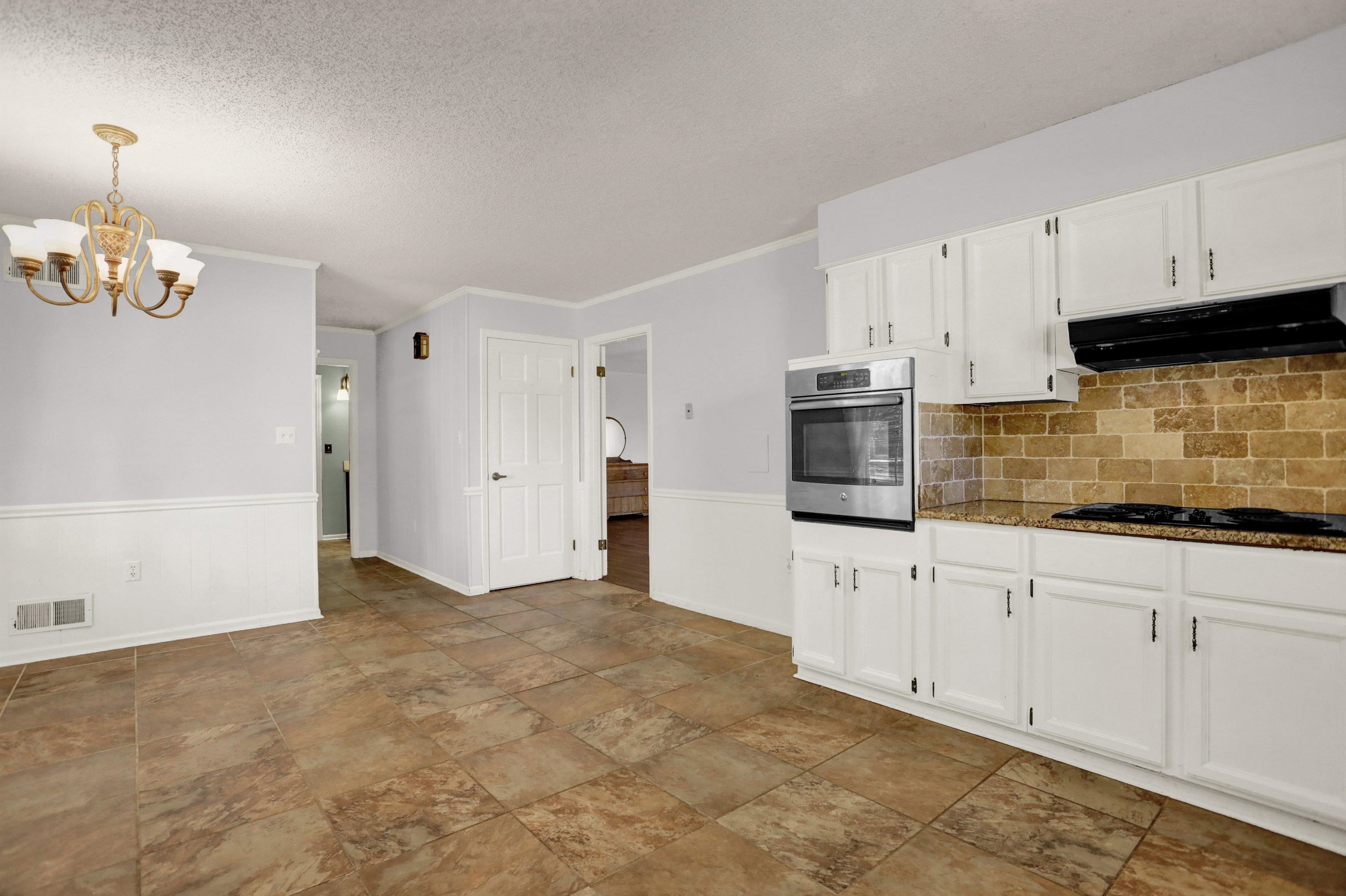 11670 Macon Road Eads, TN 38028 - Photo 10 of 40 a kitchen with granite countertop white cabinets a sink and dishwasher