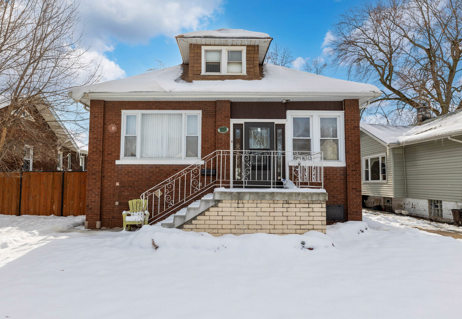 a view of a house with a wooden fence