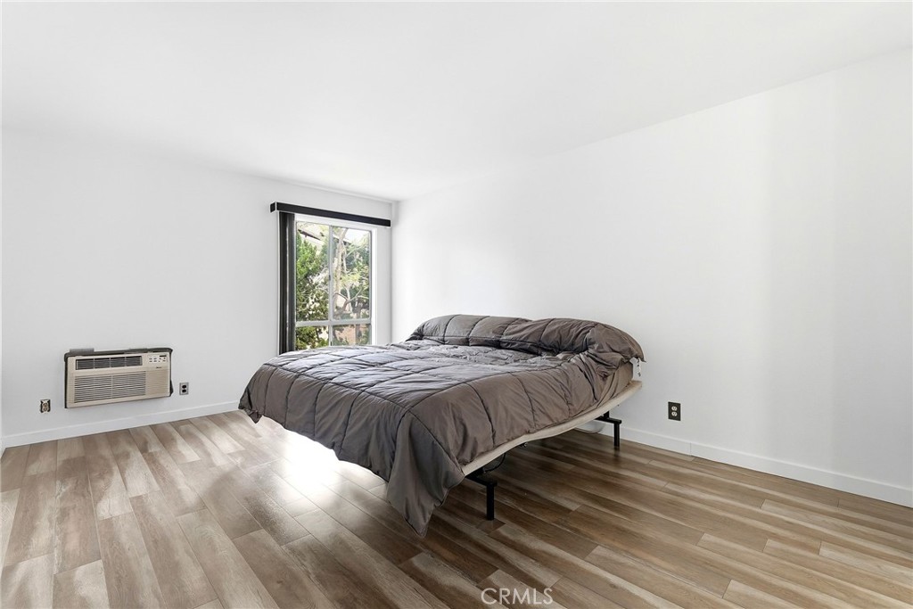 7890 East Spring Street, Unit 11E Long Beach, CA 90815 - Photo 30 of 40 a bedroom with a bed and a window
