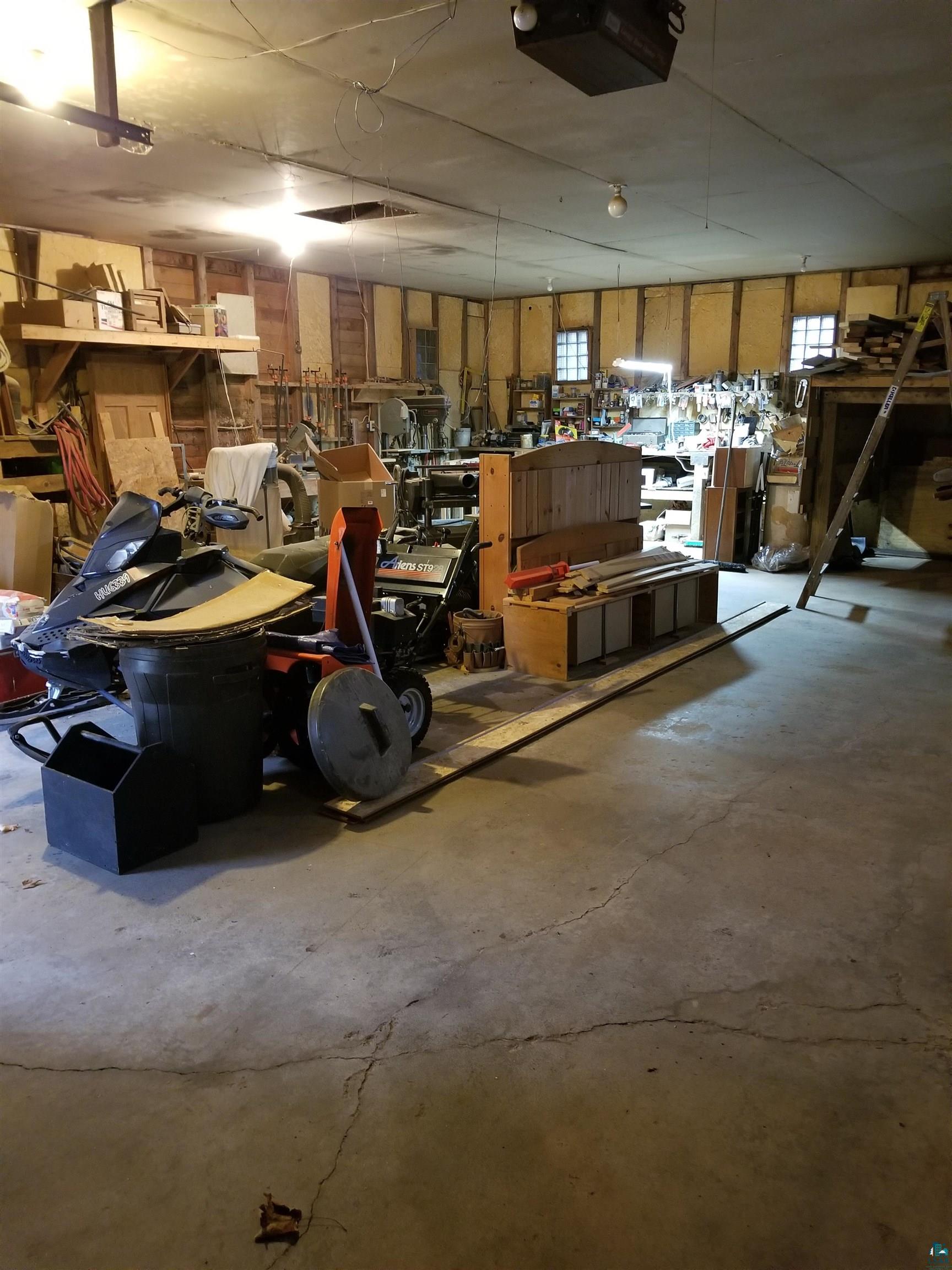6099 Jean Duluth Road Duluth, MN 55803 - Photo 31 of 35 Garage with a garage door opener and a workshop area