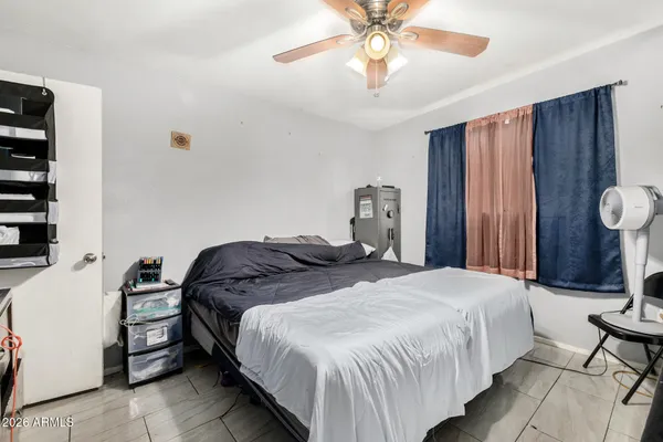 a bedroom with a bed and a chandelier
