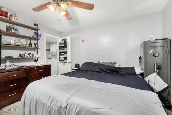 a bedroom with a large bed and a chandelier