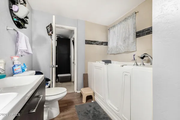 a bathroom with a sink a toilet and a shower