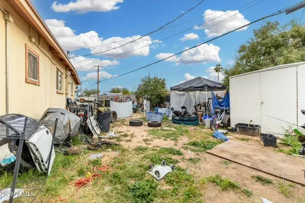 a view of a backyard with plants and patio