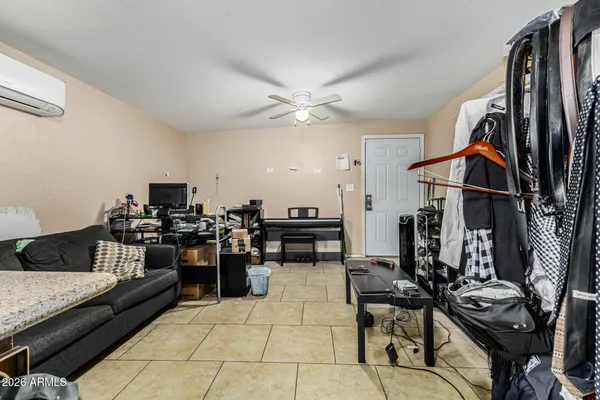 a living room with lots of furniture and black appliances
