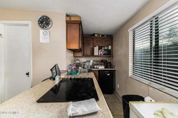 a kitchen with a refrigerator and a stove top oven