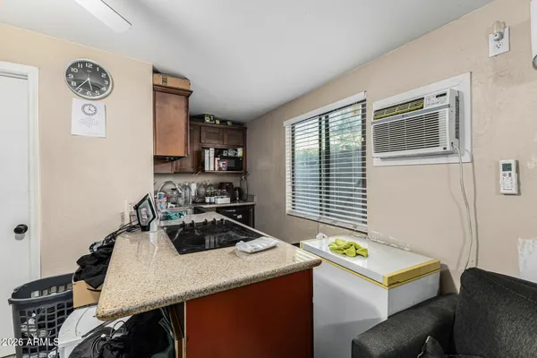 a room with a table chairs and a stove top oven