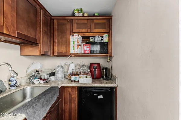 a kitchen with stainless steel appliances granite countertop a sink a stove and cabinets
