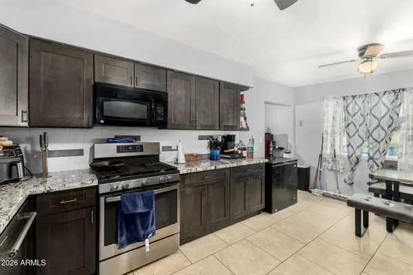 a kitchen with a sink a stove and cabinets