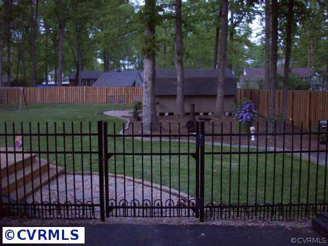 14420 Rosebud Road Chesterfield, VA 23838 - Photo 4 of 7 a view of a house with a small yard and trees in the background