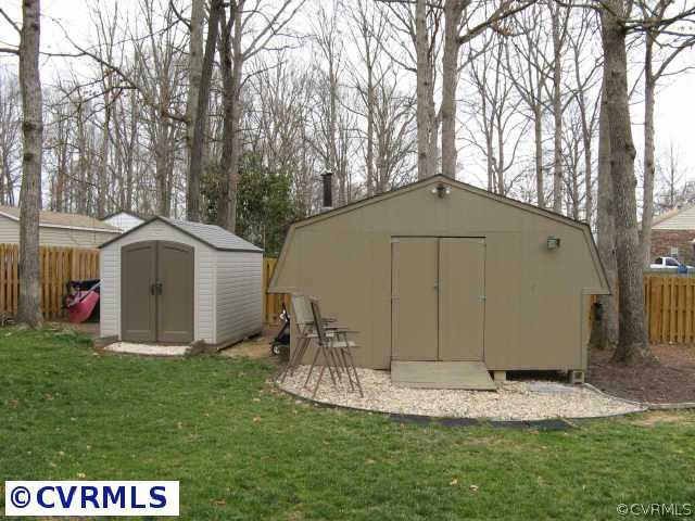 14420 Rosebud Road Chesterfield, VA 23838 - Photo 7 of 7 a view of a tiny house with a small yard and large trees