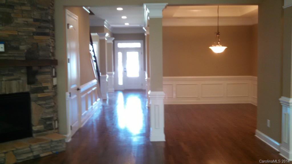 8145 Clems Branch Road Indian Land, SC 29707 - Photo 7 of 14 a view of a hallway with wooden floor and a bathroom