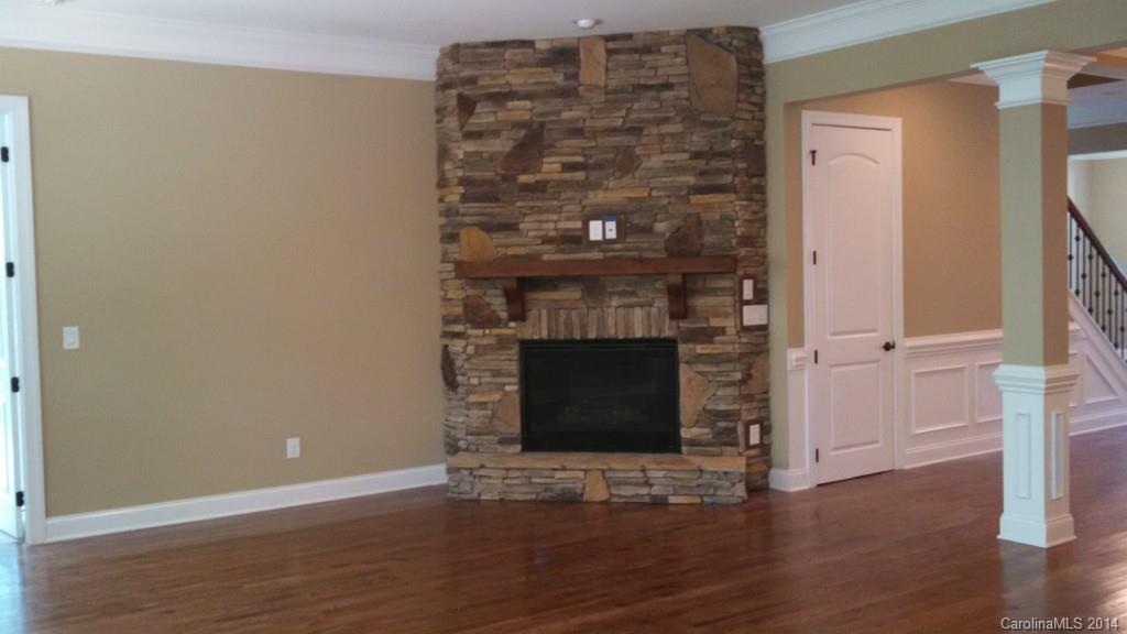 8145 Clems Branch Road Indian Land, SC 29707 - Photo 8 of 14 a view of a livingroom with wooden floor and a fireplace