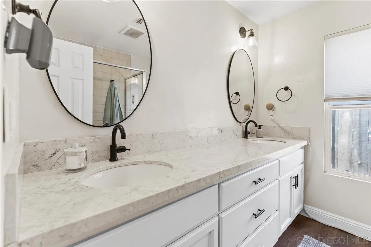 12243 Buckskin Trail Poway, CA 92064 - Photo 34 of 41 a bathroom with a double vanity sink and a mirror