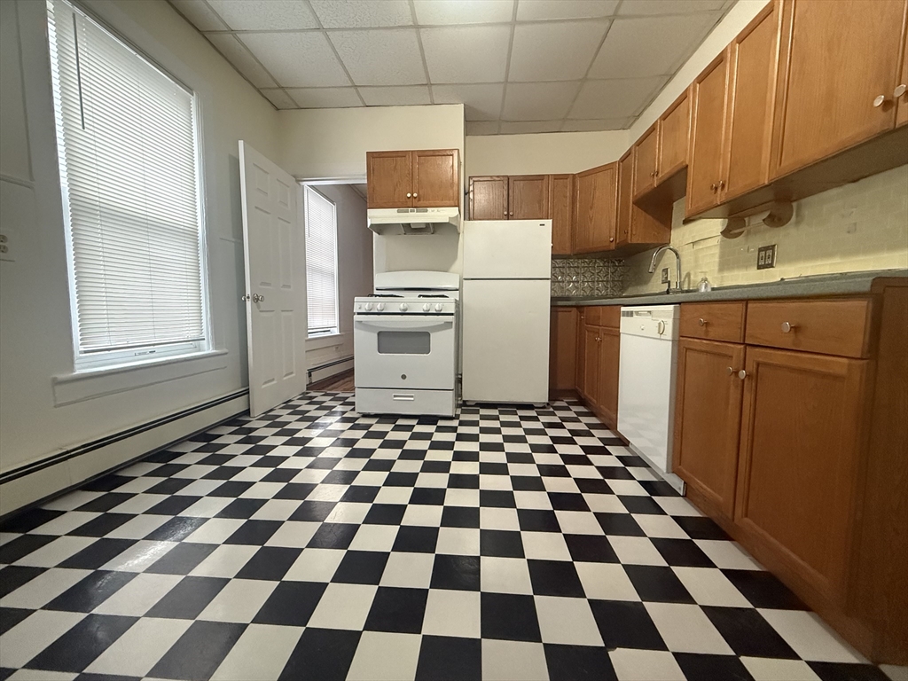 48 Florence Street, Unit 2 Somerville, MA 02145 - Photo 11 of 11 a kitchen with a checkered floor and white cabinets