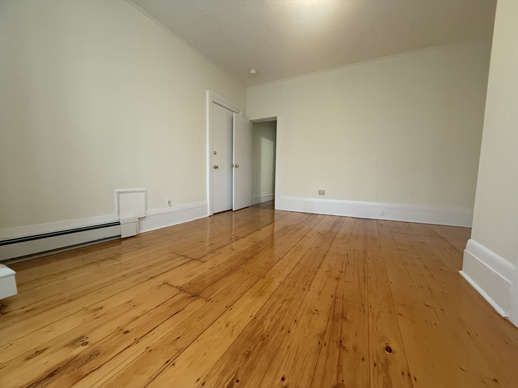48 Florence Street, Unit 2 Somerville, MA 02145 - Photo 2 of 11 a view of empty room with wooden floor