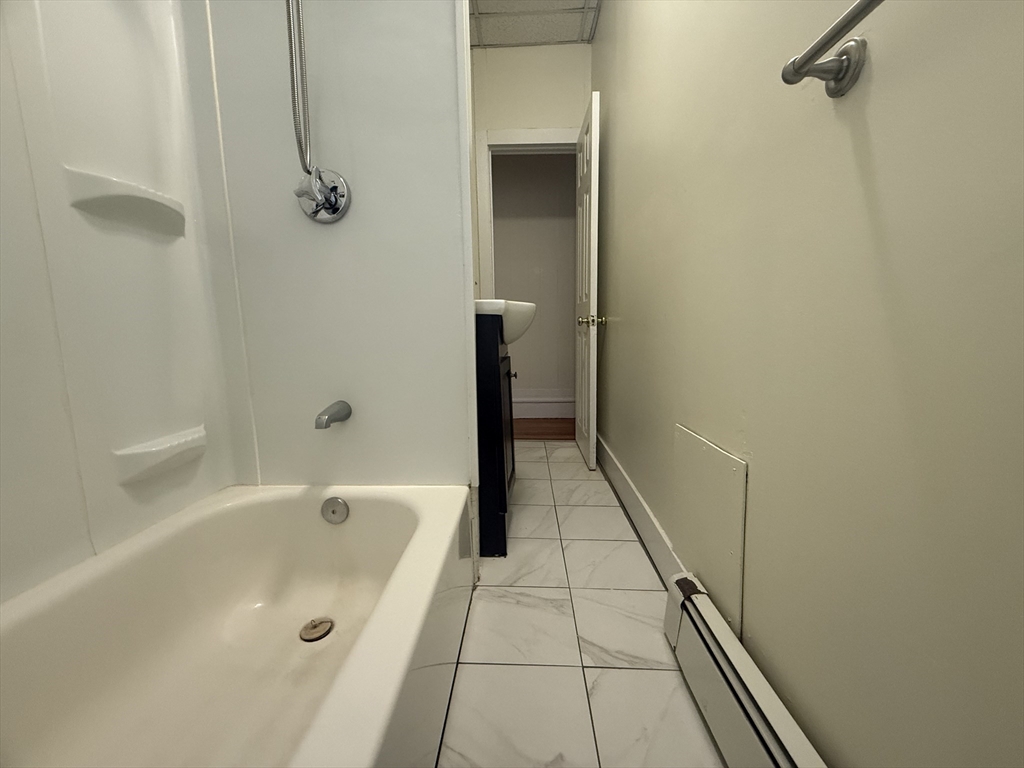 48 Florence Street, Unit 2 Somerville, MA 02145 - Photo 5 of 11 a bathroom with a bathtub