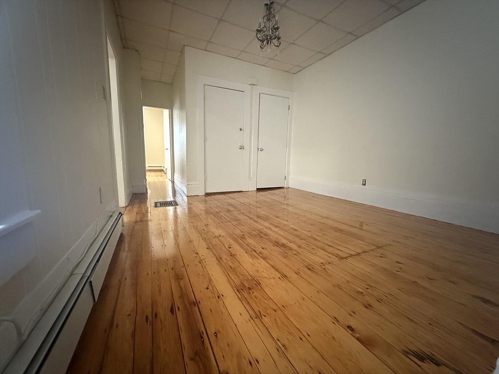 48 Florence Street, Unit 2 Somerville, MA 02145 - Photo 7 of 11 wooden floor in an empty room with a window