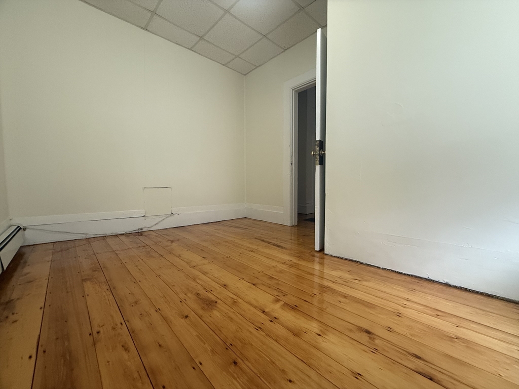48 Florence Street, Unit 2 Somerville, MA 02145 - Photo 9 of 11 a view of empty room with wooden floor