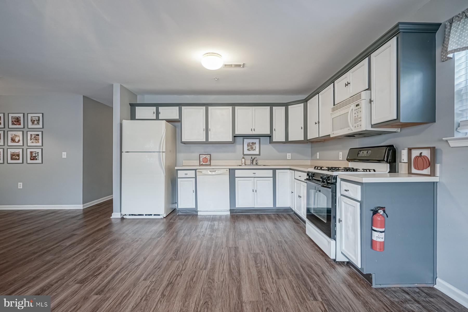 307 Red Bud Lane Mantua, NJ 08051 - Photo 9 of 21 a kitchen with cabinets wooden floor and a sink