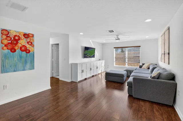 a living room with furniture and a wooden floor