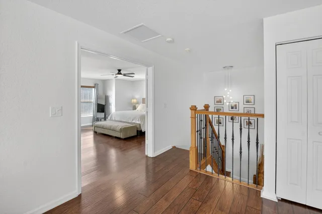 a bedroom with a large bed wooden floor and a window