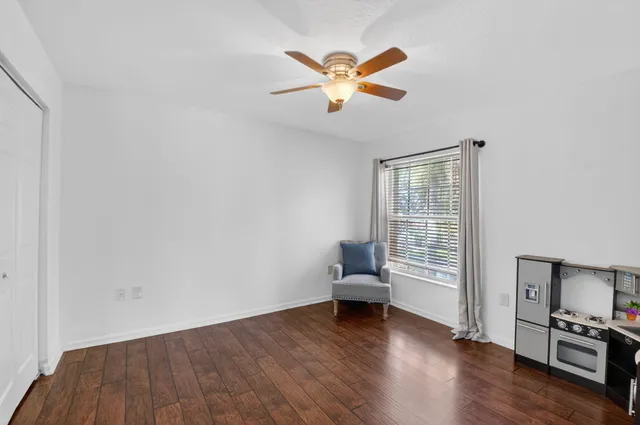 a bathroom with a granite countertop sink two mirror and shower