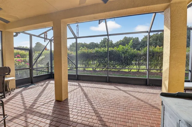 a view of a porch with a table and chairs
