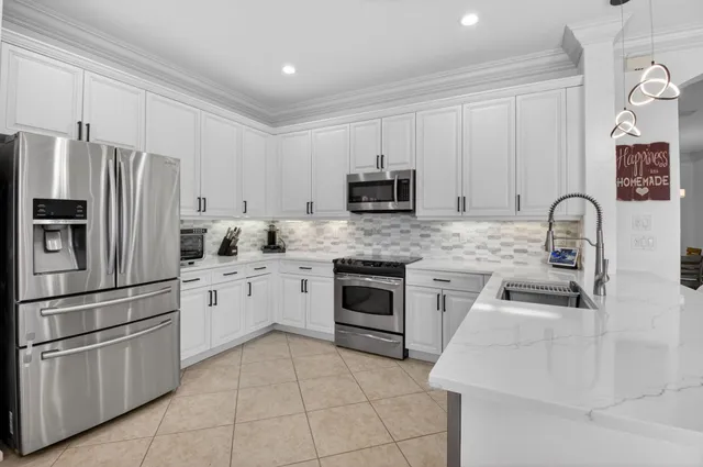 a kitchen with cabinets stainless steel appliances and a counter space