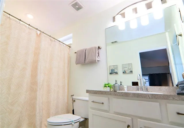 a bedroom with furniture and a flat screen tv