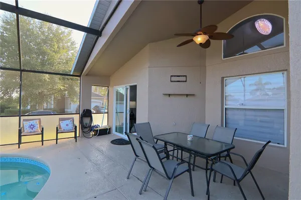 a living room filled with furniture and a large window