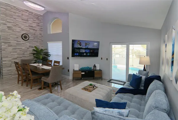 a living room with furniture and a flat screen tv