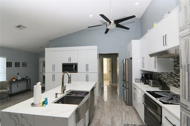 a kitchen with a stove a sink and a refrigerator