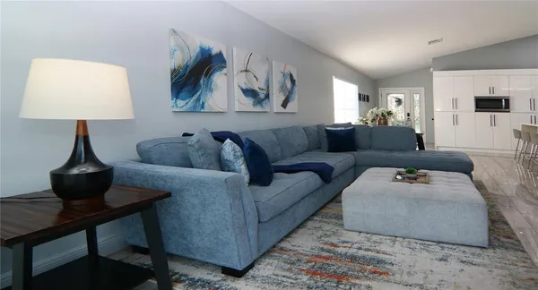 a living room with furniture and a lamp