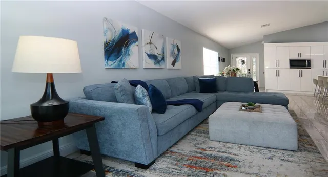 a living room with furniture and a lamp