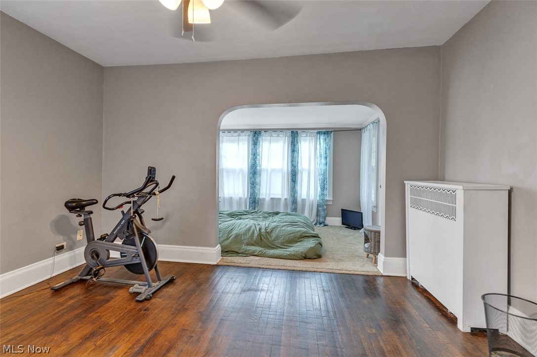 2972 Yorkshire Road Cleveland Heights, OH 44118 - Photo 28 of 44 Hardwood flooring and light gray painted walls define this interior space, featuring a classic arched doorway opening to an additional room