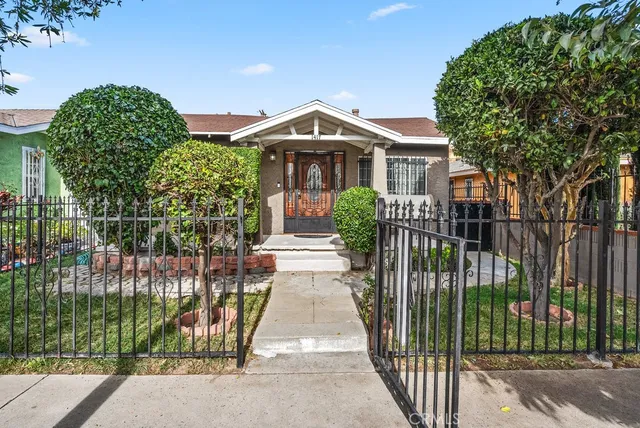 a front view of a house with a garden
