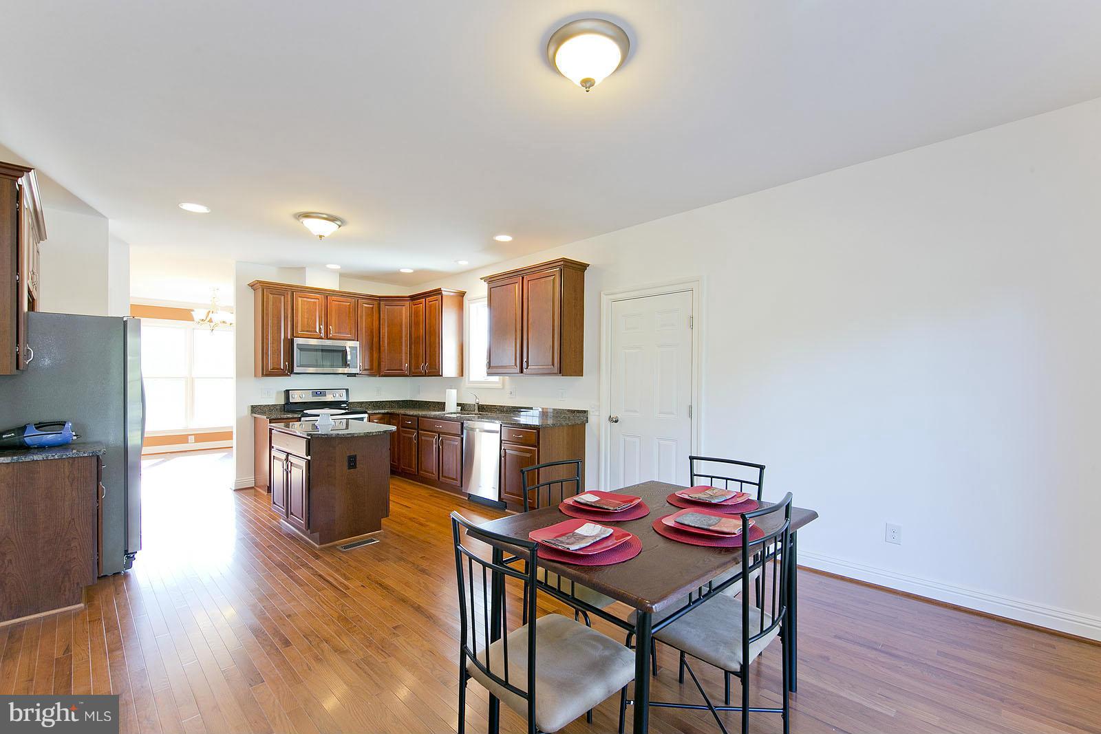 481 Bowling View Road Front Royal, VA 22630 - Photo 13 of 30 a kitchen with stainless steel appliances granite countertop a kitchen island hardwood floor sink stove dining table and chairs