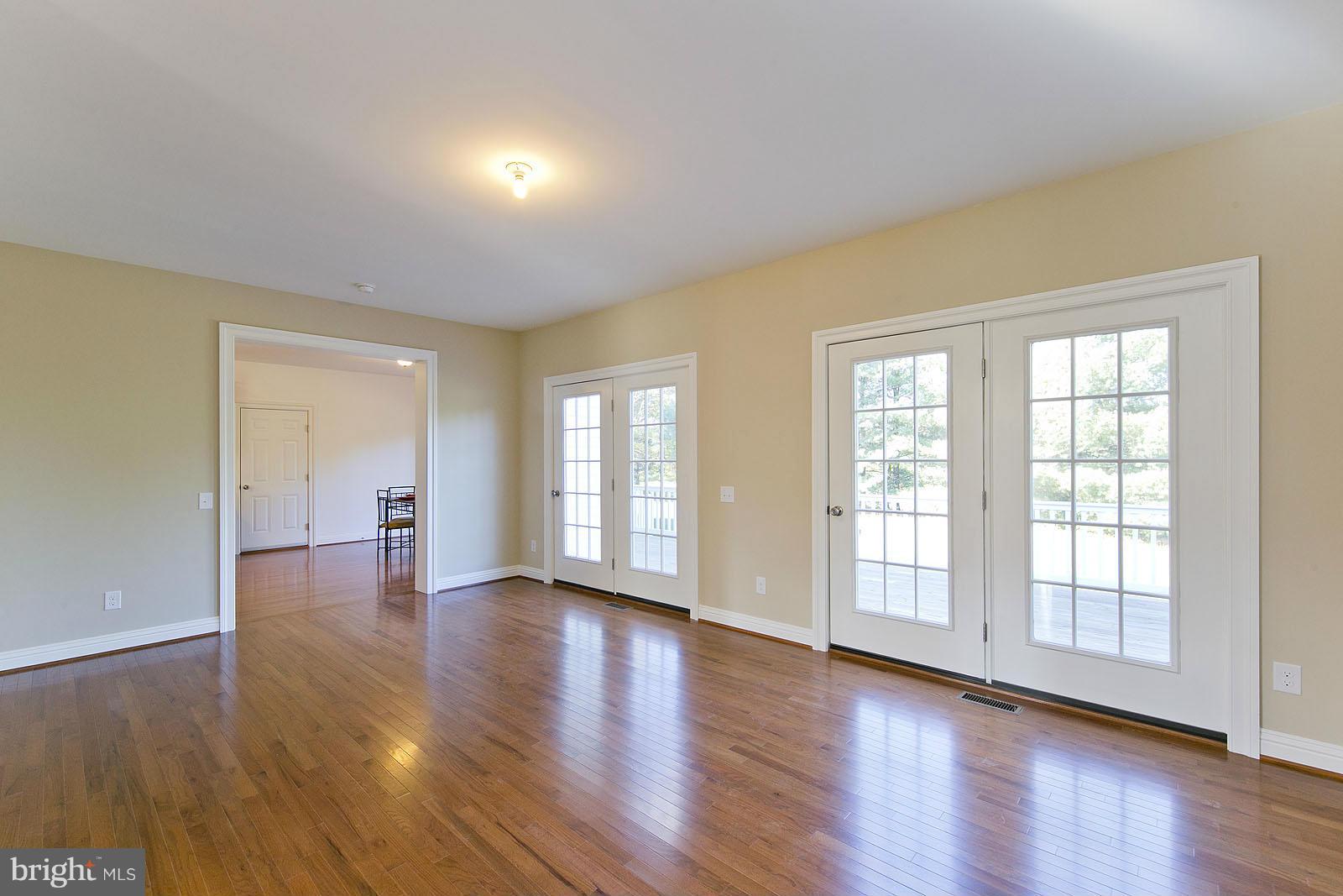 481 Bowling View Road Front Royal, VA 22630 - Photo 3 of 30 an empty room with wooden floor and windows
