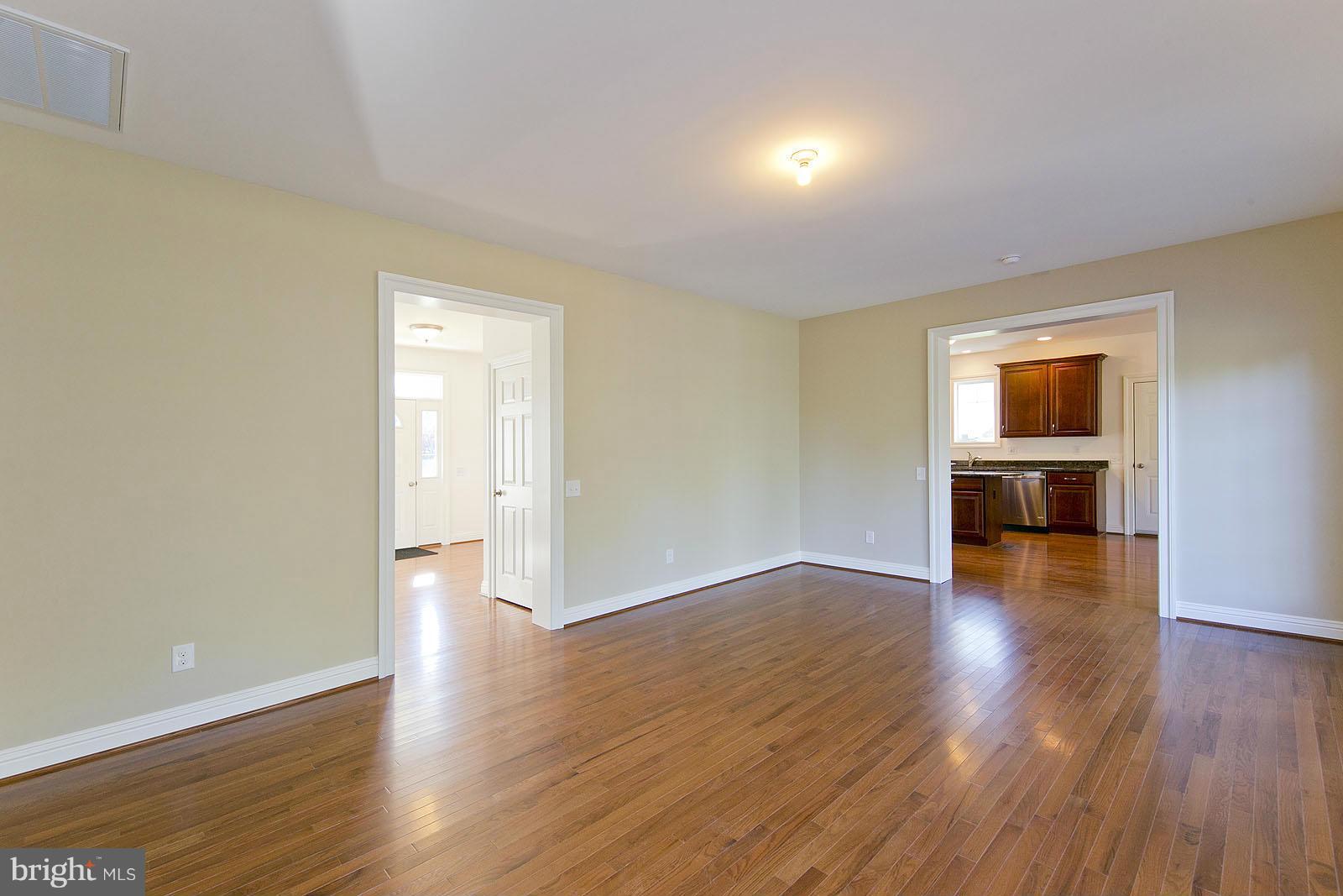 481 Bowling View Road Front Royal, VA 22630 - Photo 4 of 30 a view of empty room with wooden floor and fireplace