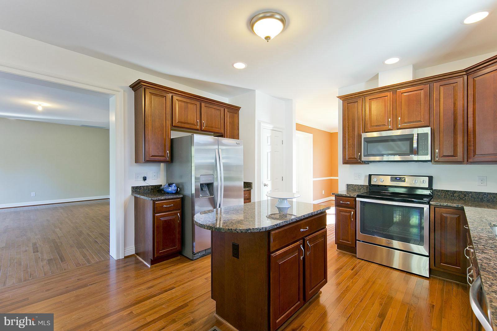 481 Bowling View Road Front Royal, VA 22630 - Photo 9 of 30 a kitchen with granite countertop a stove top oven and sink